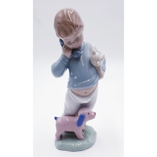 303 - LLADRO (Nao) PORCELAIN 19cm CHARACTER FIGURINE OF A YOUNG BOY ON THE TELEPHONE With PUPPETS