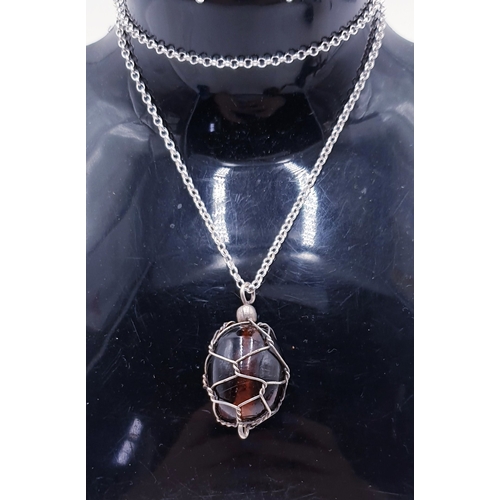 201 - SILVER (925) CAGED AMBER PENDANT ON A SILVER (925) 42cm NECK CHAIN (Total Weight 14 Grams)