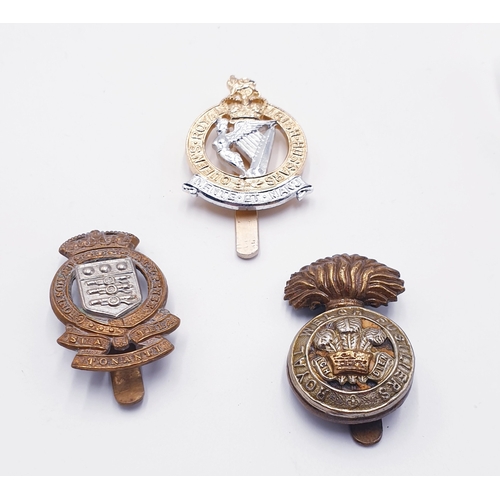 741 - ROYAL WELSH FUSILIERS CAP BADGE, ROYAL ORDENANCE CAP BADGE & QUEENS ROYAL IRISH HUSSARS CAP BADGE