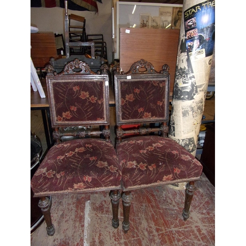 404 - Two late Victorian hand carved chairs featuring Rams head chair top finials