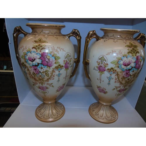 168 - A pair of hand decorated Crown Devon vases