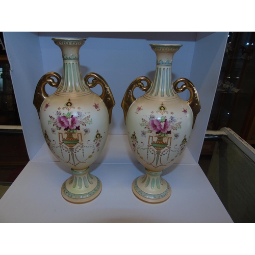 184 - A pair of Crown Devon handled ewers. 