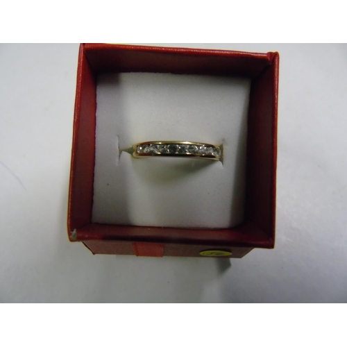 162 - A 9ct gold white sapphire half eternity ring size P