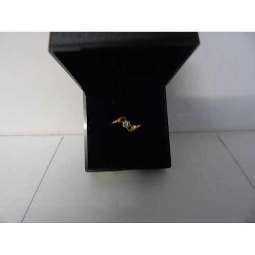 157 - A 9ct gold & diamond solitaire twist ring size J 1/2