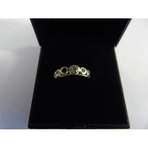 131 - A 18ct gold ruby, sapphire & white topaz ring size M