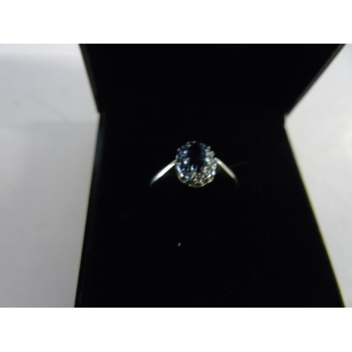 142 - A 9ct gold diamond & blue topaz ring size J 1/2