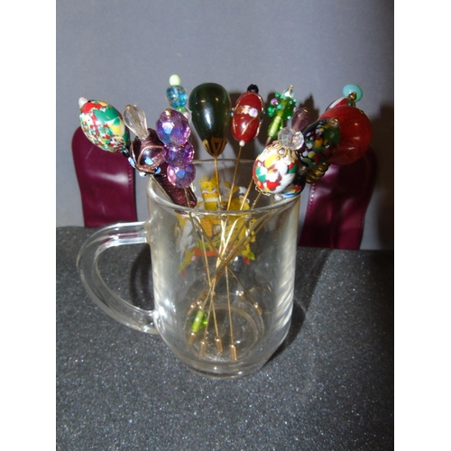 100 - A collection of twelve vintage style hat pins with glass beads