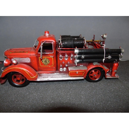 7 - A good tin plate model of a vintage fire engine. 47cm long