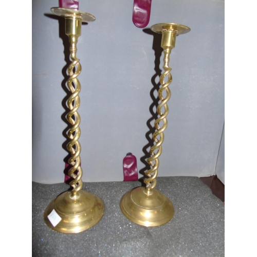 25 - Two large antique twisted stem brass candlesticks. 45cm tall