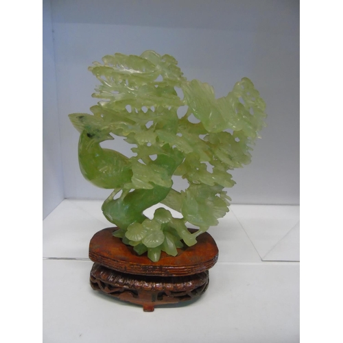 120 - A beautiful Chinese light green jade sculpture on a wooden stand. jade piece only 15cmx17cm