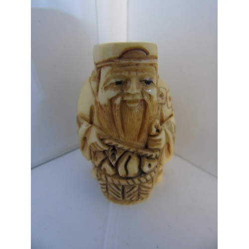 134 - A carved bone & signed Netsuke