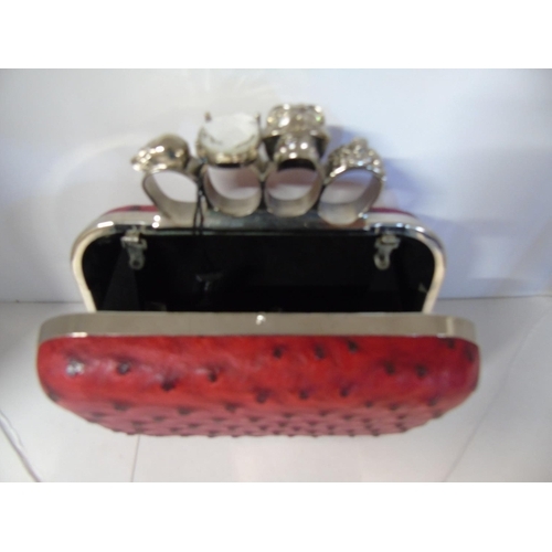 8 - A boxed as new Ladies Malissa knuckle duster clutch bag