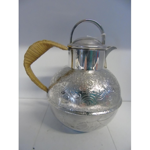 474 - A quality silver plated and wicker handled i/2 pint jug