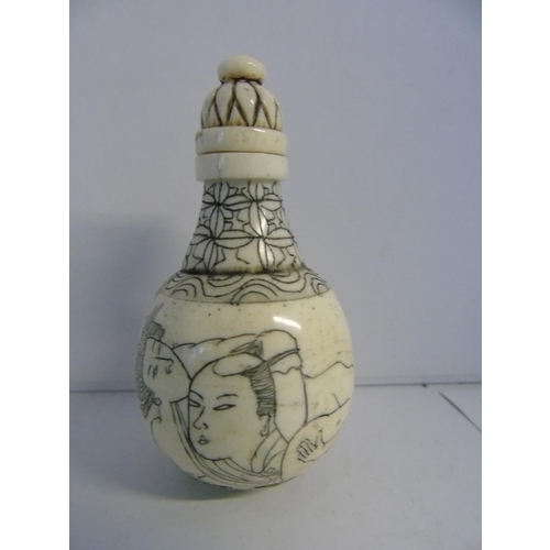 468 - A Chinese carved & decorated bone snuff bottle