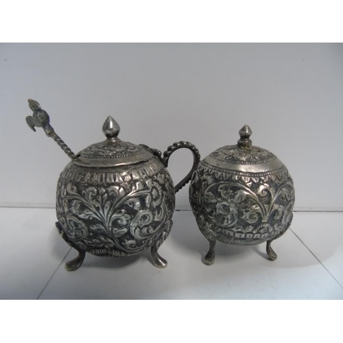 104 - A continental white metal mustard pot & spoon and matching pepperette (slight dent to the mustard po... 