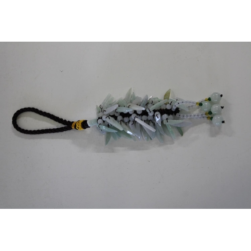 628 - A Chinese jade tassel with celadon coloured beads