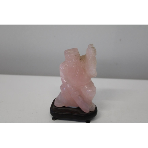 601 - A pink jade Chinese deity figure 10cm tall