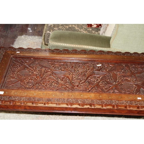 631 - An ornately carved coffee table with brass inlay