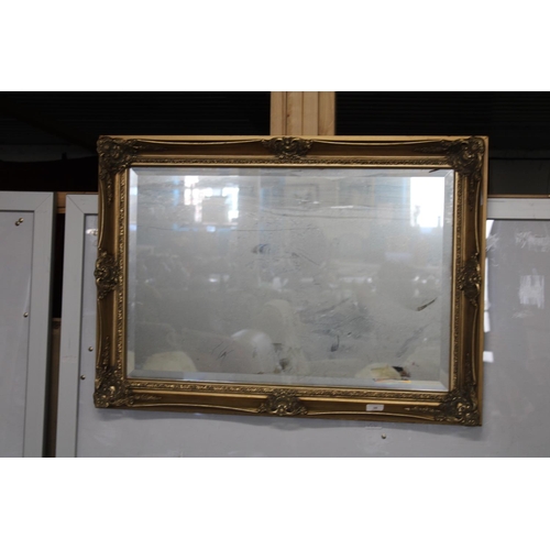 98 - A vintage bevelled edged glass mirror 90cm x 63cm
Collection Only