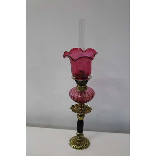 15A - A vintage brass & cranberry glass oil lamp.
Height 56cm