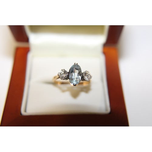 195 - A 18ct gold & platinum ring with a central aquamarine stone flanked by two large diamonds size J 1/2