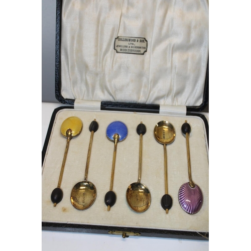 42 - A cased set of six hallmarked silver & gilt coffee spoons with guilloche enamel decoration. Hallmark... 