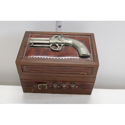 362 - A novelty wooden box with gun decoration to lid