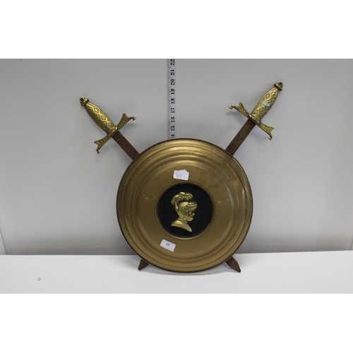 48 - A novelty brass shield and sword wall hanger