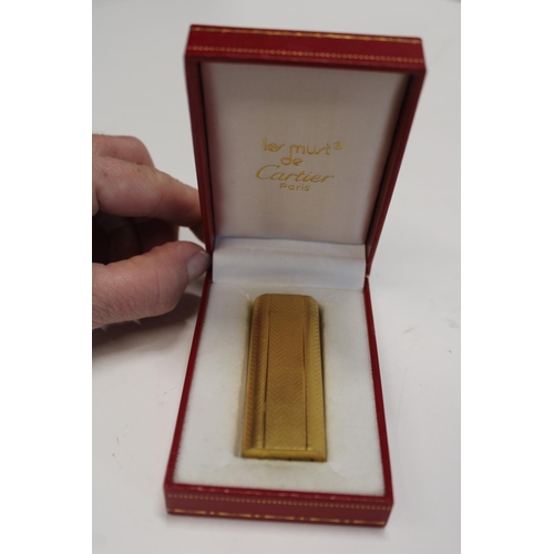 16 - A Cartier Lighter in fitted case. Gold Plated Serial no. 72914K.