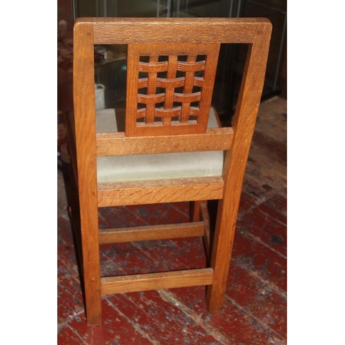 98 - Four vintage Derek 'Lizardman' Slater oak dining chairs with lattice work backs. All with a carved l... 