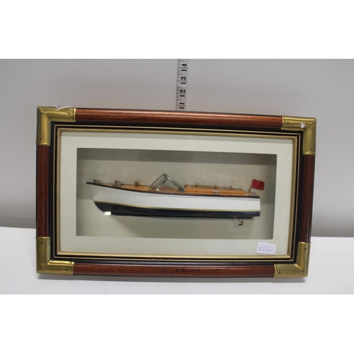 192 - A model speed boat in a wall hanging display case