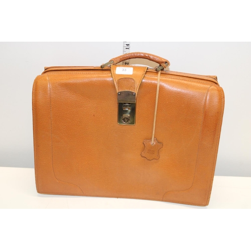 33 - A vintage genuine pig skin brief case