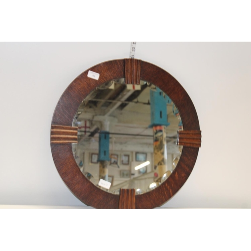 86 - A 1930's oak framed mirror. Postage unavailable. dia 54cm