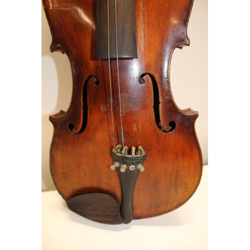 44 - An antique Stradivarius copy violin in an early coffin carry case with bows (Sold as seen)