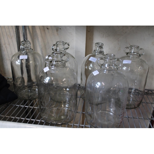 429 - Six glass demijohns bottles. Postage unavailble