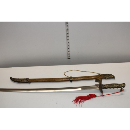 26 - A reproduction sword and scabbard. postage unavailable