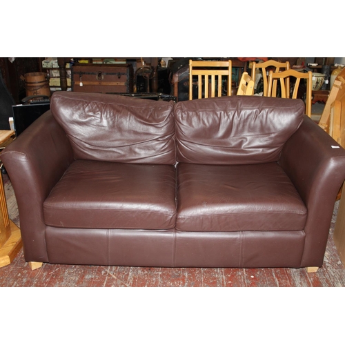 414 - A brown two seater sofa. Postage unavailable