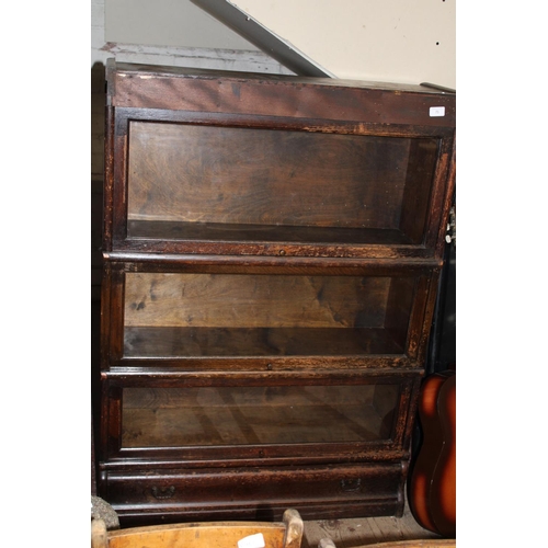 75 - A antique globe Wernicke three tier bookcase with under drawer. Postage unavailable