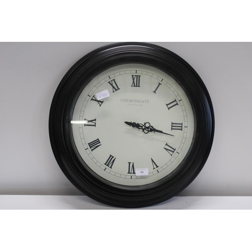 89 - A modern station style battery powered wall clock. Postage unavailable