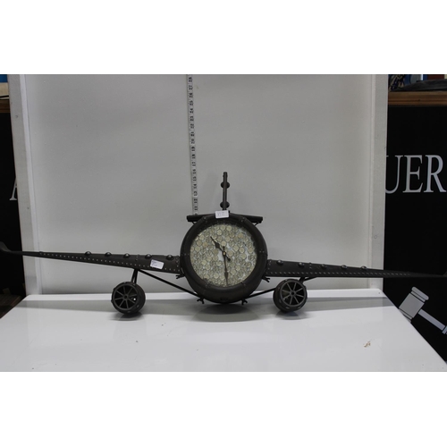 91 - A unusual very large metal aeroplane wall clock with 5ps applied to the face. Postage unavailable