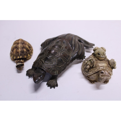 134 - Three assorted tortoise figures one possibly bronze Japanese. a/f