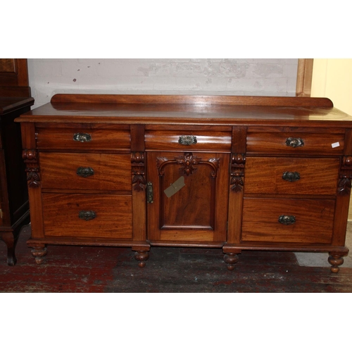 393 - A large oak sidebaord with middle cupboard and six drawers, with key collection only