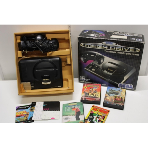 52 - A boxed Sega Mega drive with an assortment of games and accessories