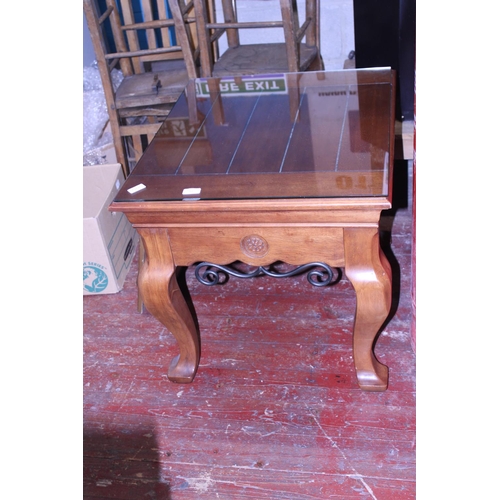 92 - A heavy solid wood coffee table with glass top. postage unavailable