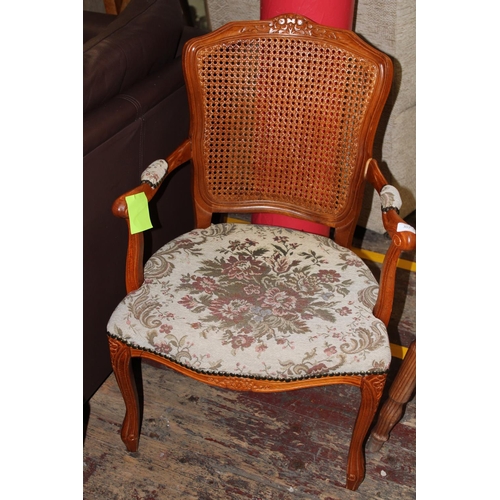 348 - An upholstered rattan back arm chair. collection only