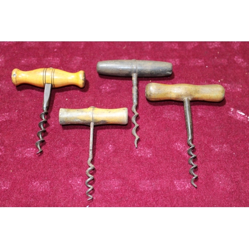 104 - Four antique treen handled corkscrews