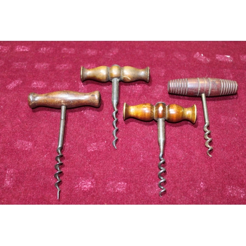 106 - Four antique treen handled corkscrews