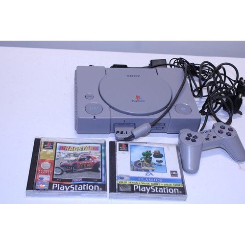 243 - A Sony Playstation One with controllers and games