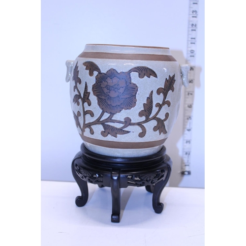 9 - A Oriental vase on wooden stand