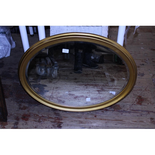 250 - A large bevelled edge glass gilt framed oval mirror, shipping unavailable